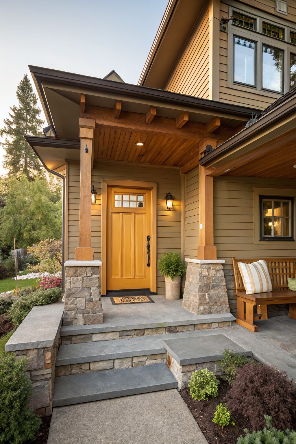 Craftsman-style house exterior with a yellow wood front door under a covered porch supported by timber posts and stone pillars, surrounded by landscaping and steps leading up from a stone walkway.