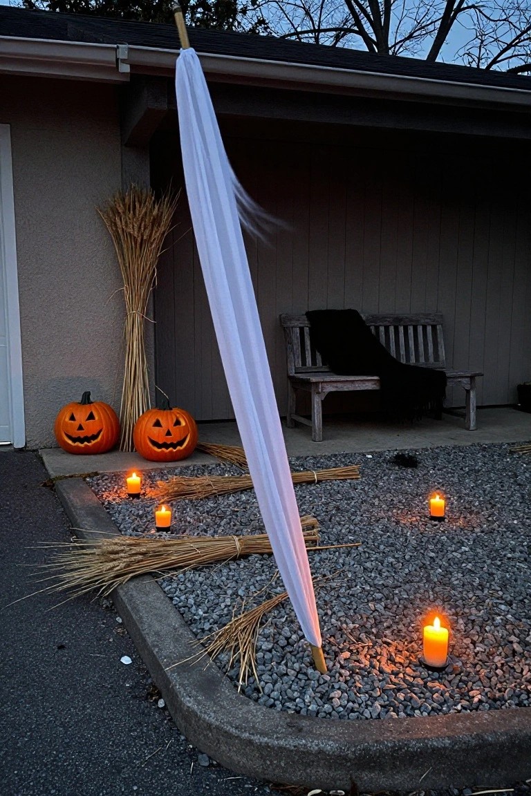 Backyard pool at dusk under a wooden pergola draped in black sheers, with black Adirondack chairs, stone planters, stacks of old books on a stool, lit jack-o-lanterns on the wet wooden deck and one floating in the pool.