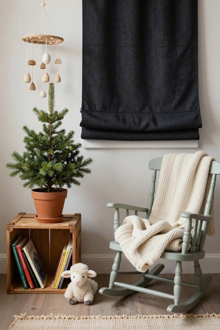 A small potted Christmas tree on a wooden crate next to a green rocking chair draped with a white knitted blanket in a nursery corner, with books on the shelf, a stuffed white lamb on the floor, and a woven mobile hanging nearby against a dark curtain wall.