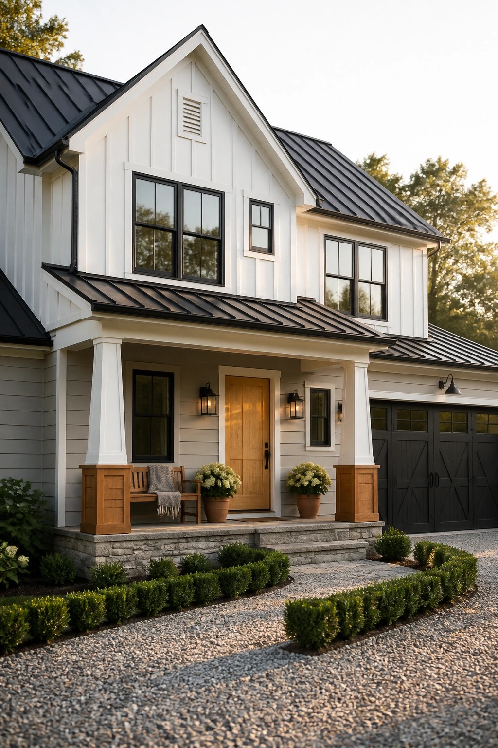 A two-story modern farmhouse with white siding, black metal roofing, black-framed windows, a wooden front door, and a covered porch with white columns.