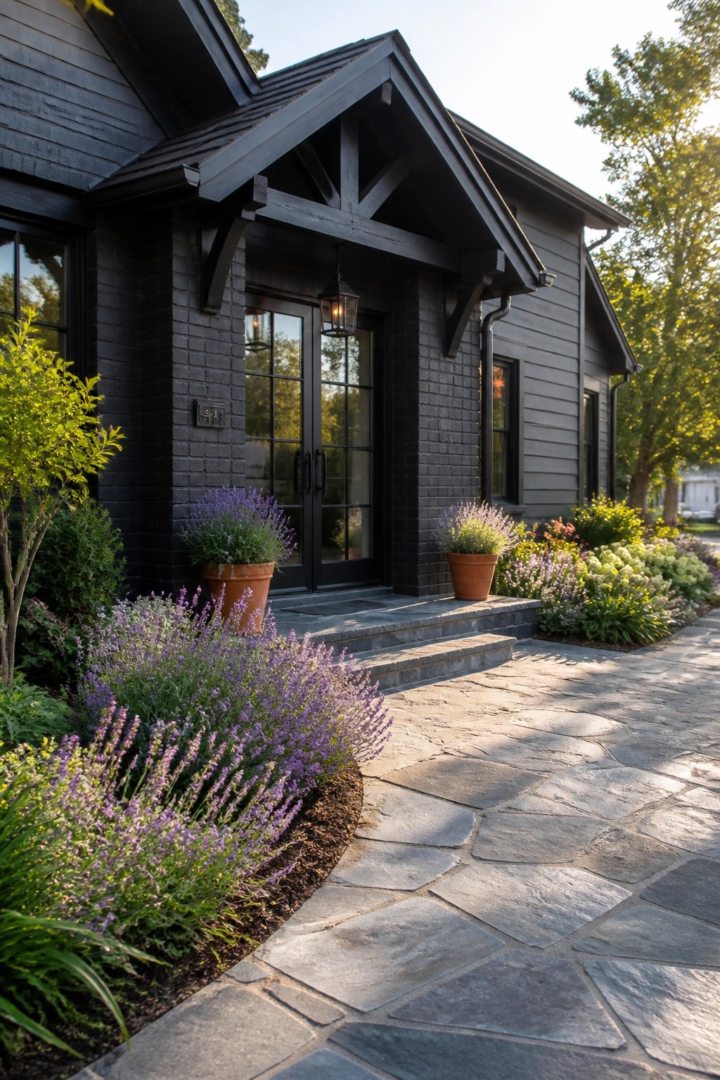 Dark house with lantern, stone steps, purple flowers, and potted plants along walkway