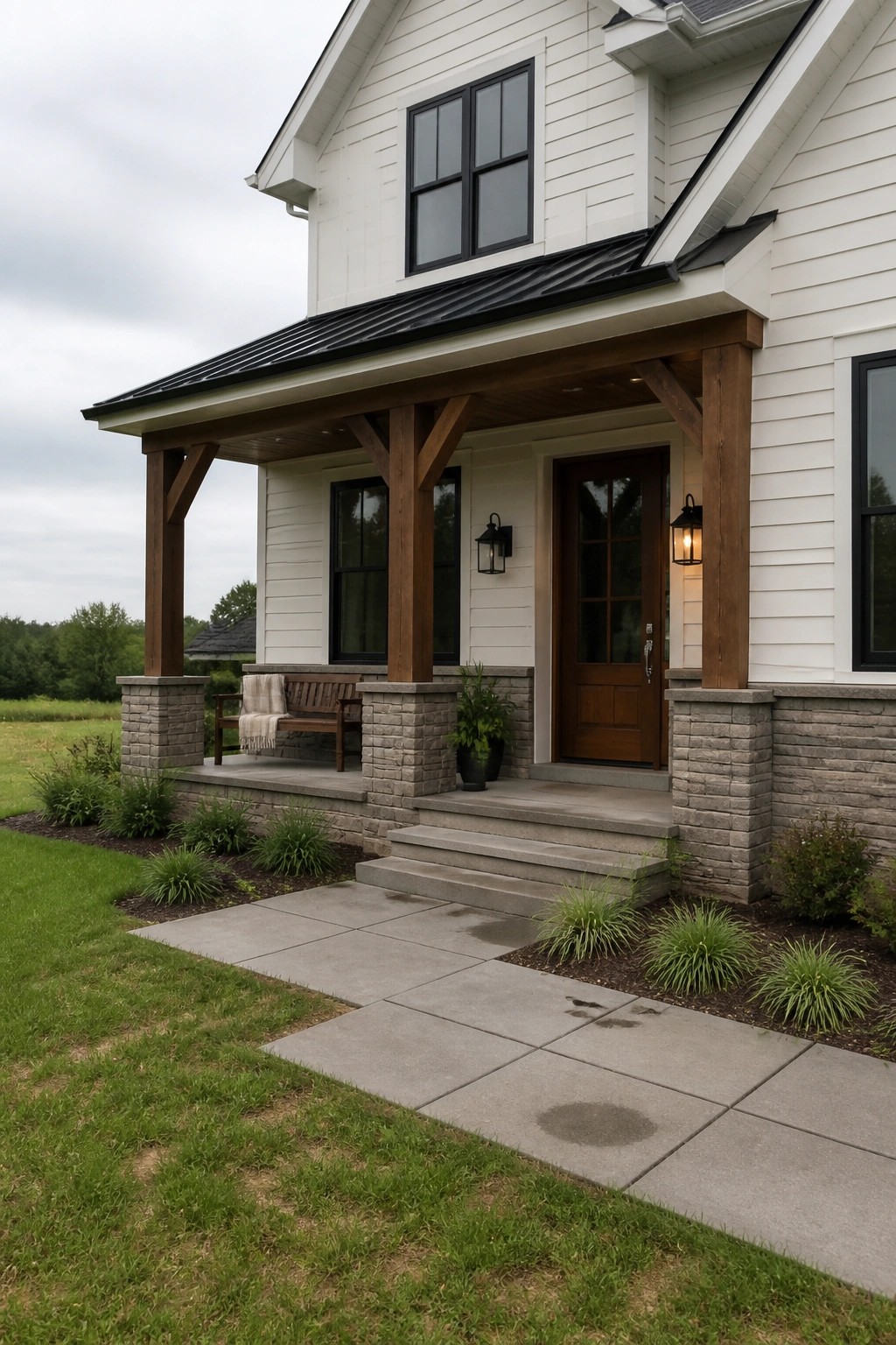 White vinyl siding on a house exterior with gray stone porch pillars and dark wood beams.