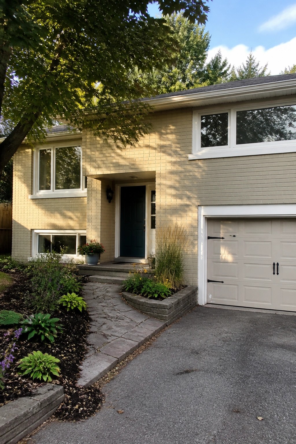 Beige siding on a traditional suburban house with white trim and garage door.