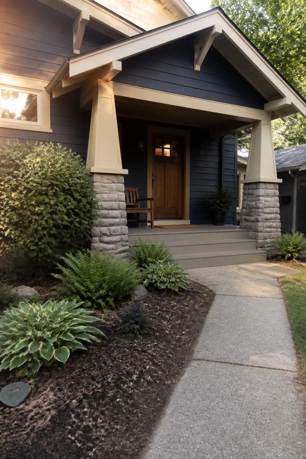Dark navy blue siding on a house porch with stone pillars and cream trim.