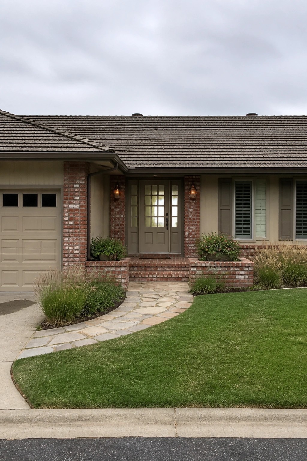 Brick house with green double doors, stone pathway, and landscaped front yard under overcast sky