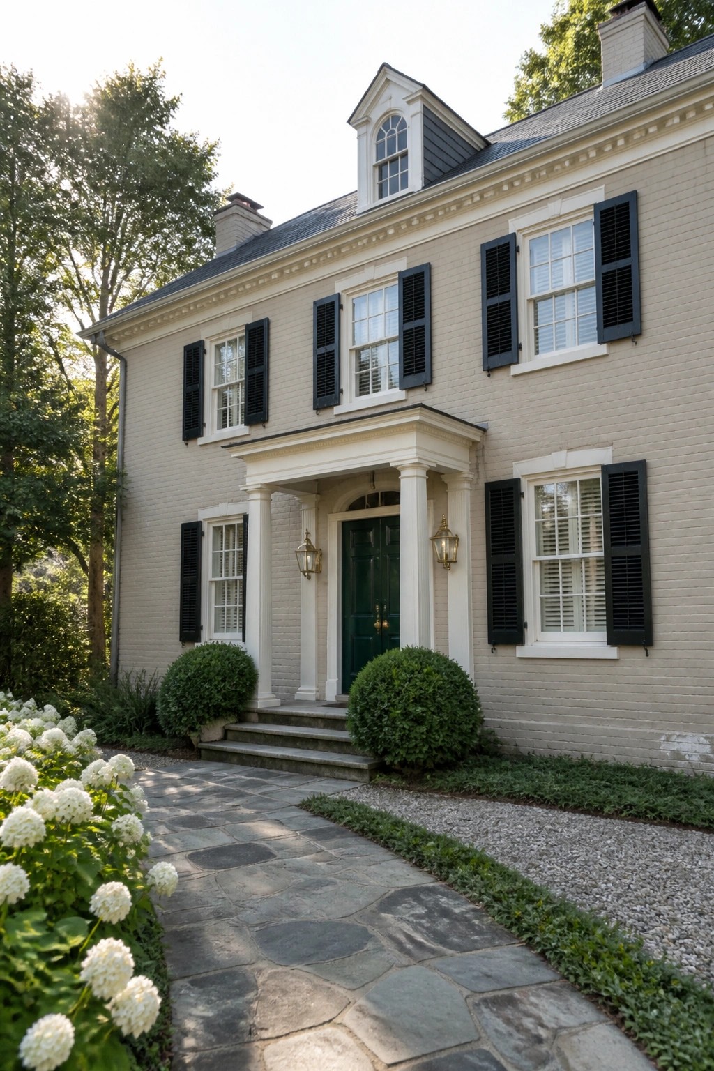 Colonial house exterior in a warm cream paint color with white trim and columns.