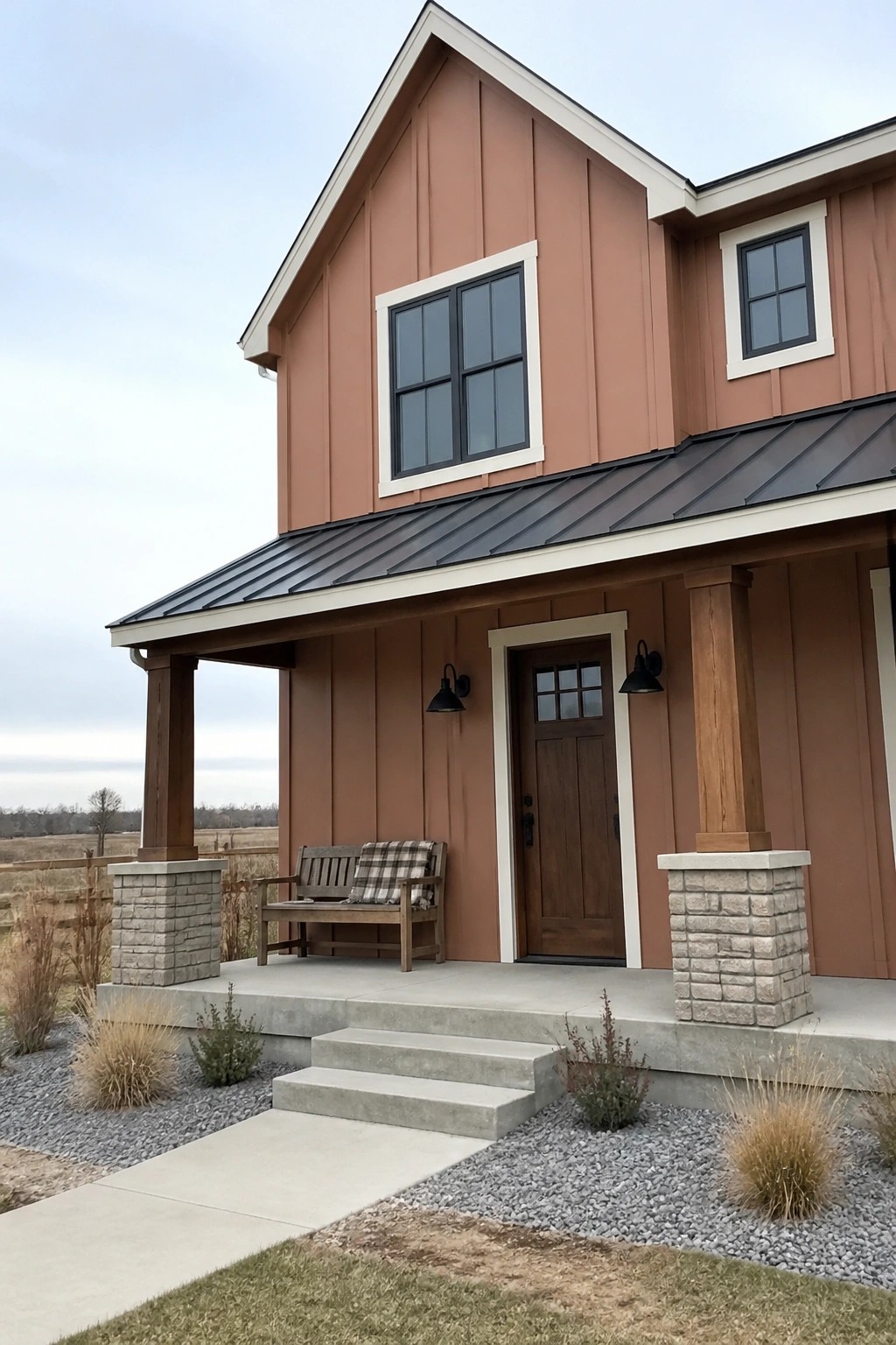 House exterior painted in warm terracotta siding with wood columns and stone bases.