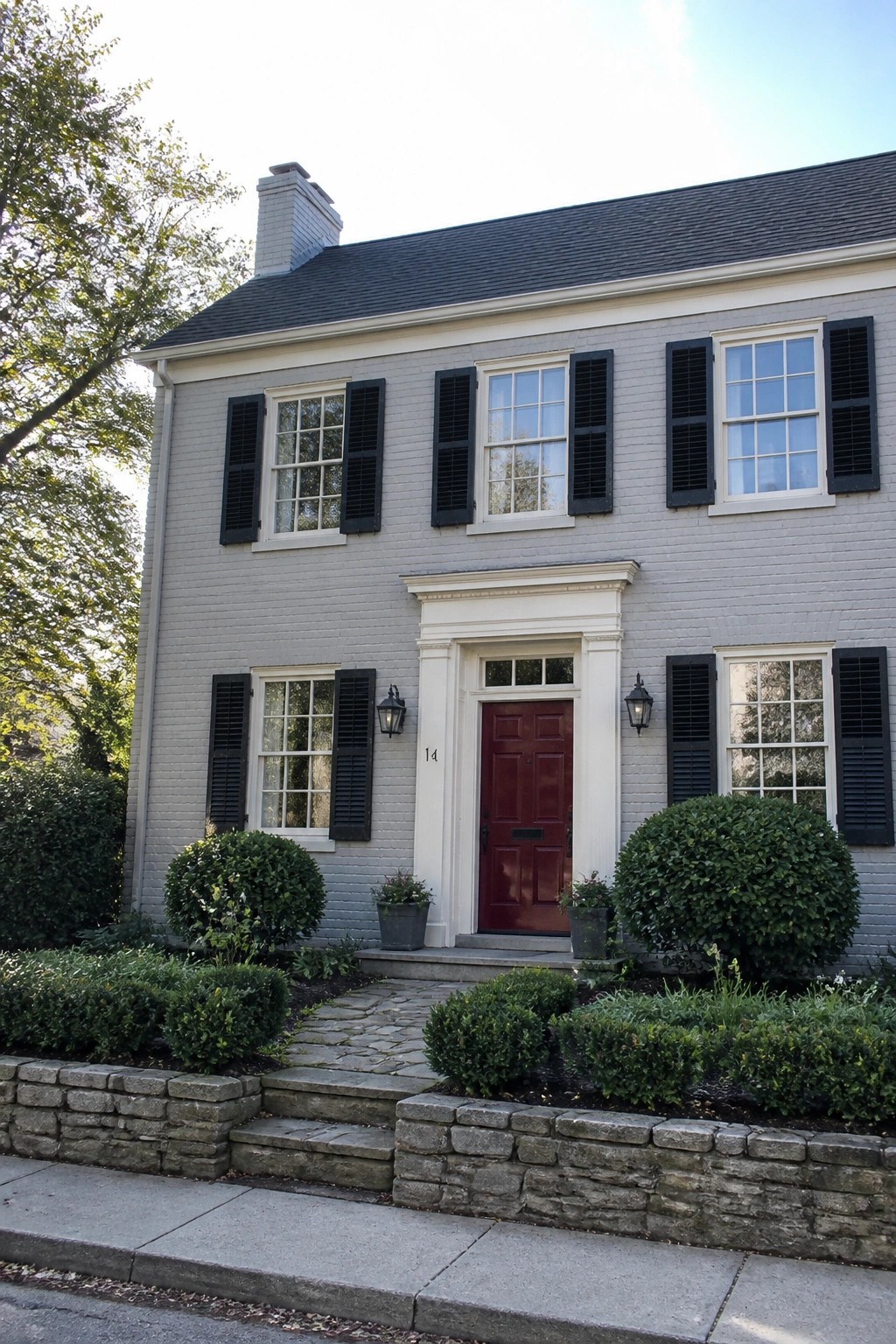 Two-story house with soft gray siding and white trim.