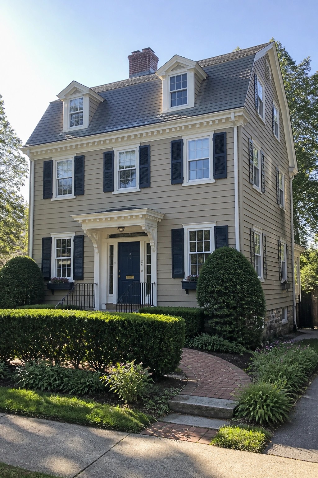 A two-story house with warm beige siding and white trim.
