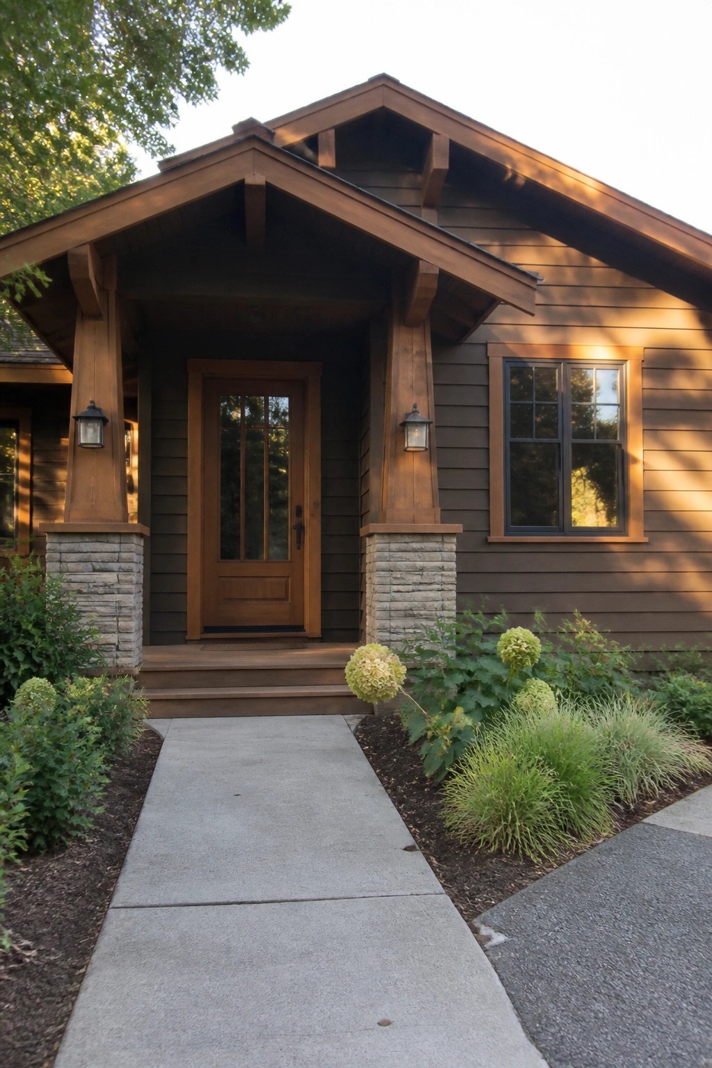 Brown wooden house entrance with stone pillars, door, window, and hydrangeas