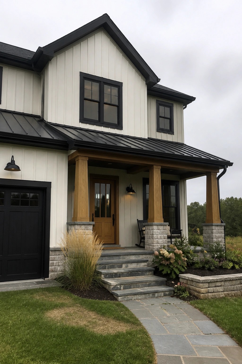 Warm white siding on a modern house exterior with black trim, windows, and stone details.