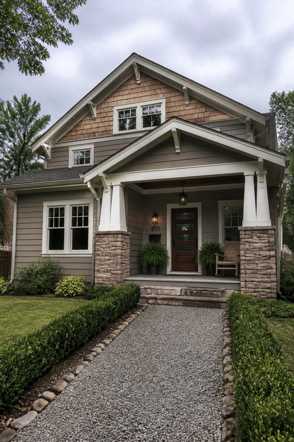 Taupe house siding next to stone porch columns on a traditional exterior.