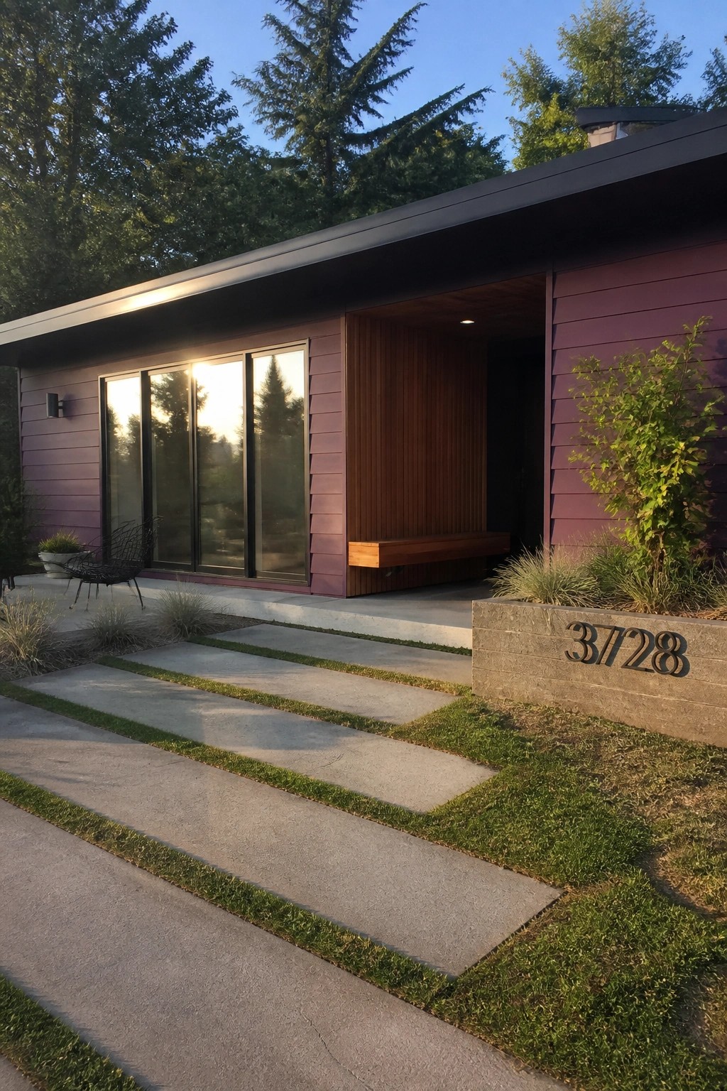Modern house exterior with deep purple horizontal lap siding, large windows, and a recessed entry with a built-in bench.
