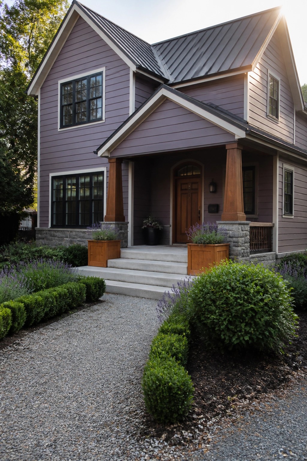 A two-story house with purple horizontal lap siding, white trim, a front porch with wooden columns and stone bases, and a gravel path with shrubs.