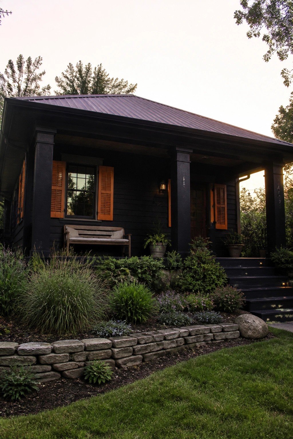 Black house with orange shutters, porch bench, stone steps, and garden