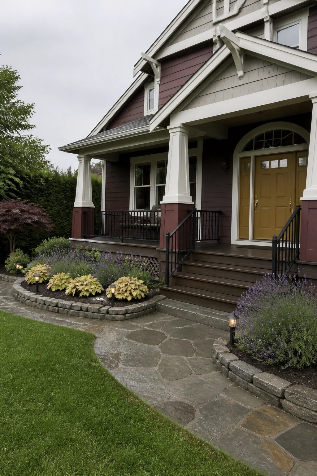 A two-story house with maroon fiber cement siding, white trim, a covered front porch with white columns, a mustard-yellow door, and a curved stone pathway.