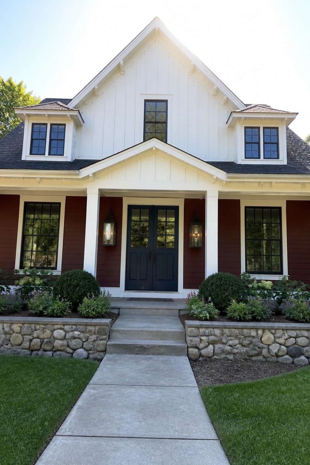 Red and white house with dark blue doors, lanterns, stone walls, and walkway.