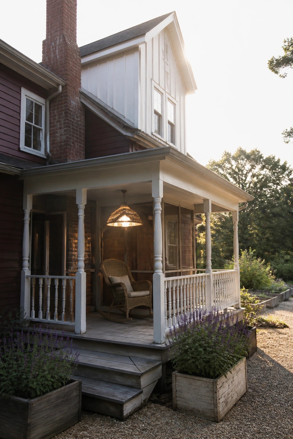 Red house porch with white railings, wicker rocker, hanging lamp, and lavender planters