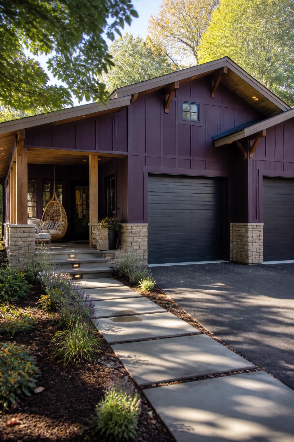 Modern purple house with black garage doors, stone accents, porch, and stone pathway.