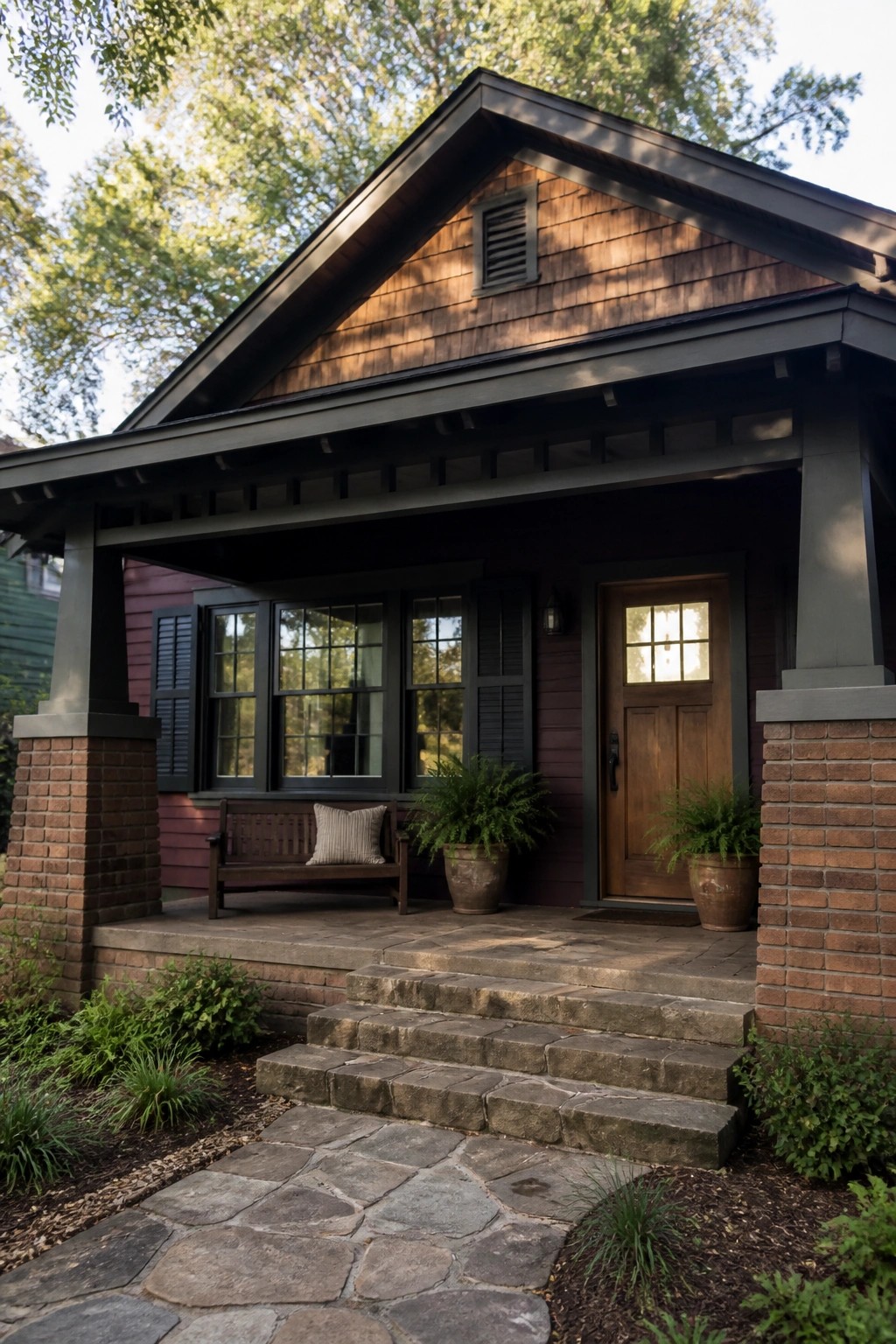 Cozy wooden porch with bench, potted ferns, stone steps, and front door.