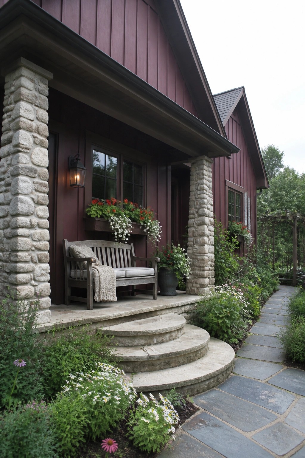 Maroon house porch with wooden bench, stone steps, flower boxes, and garden path.