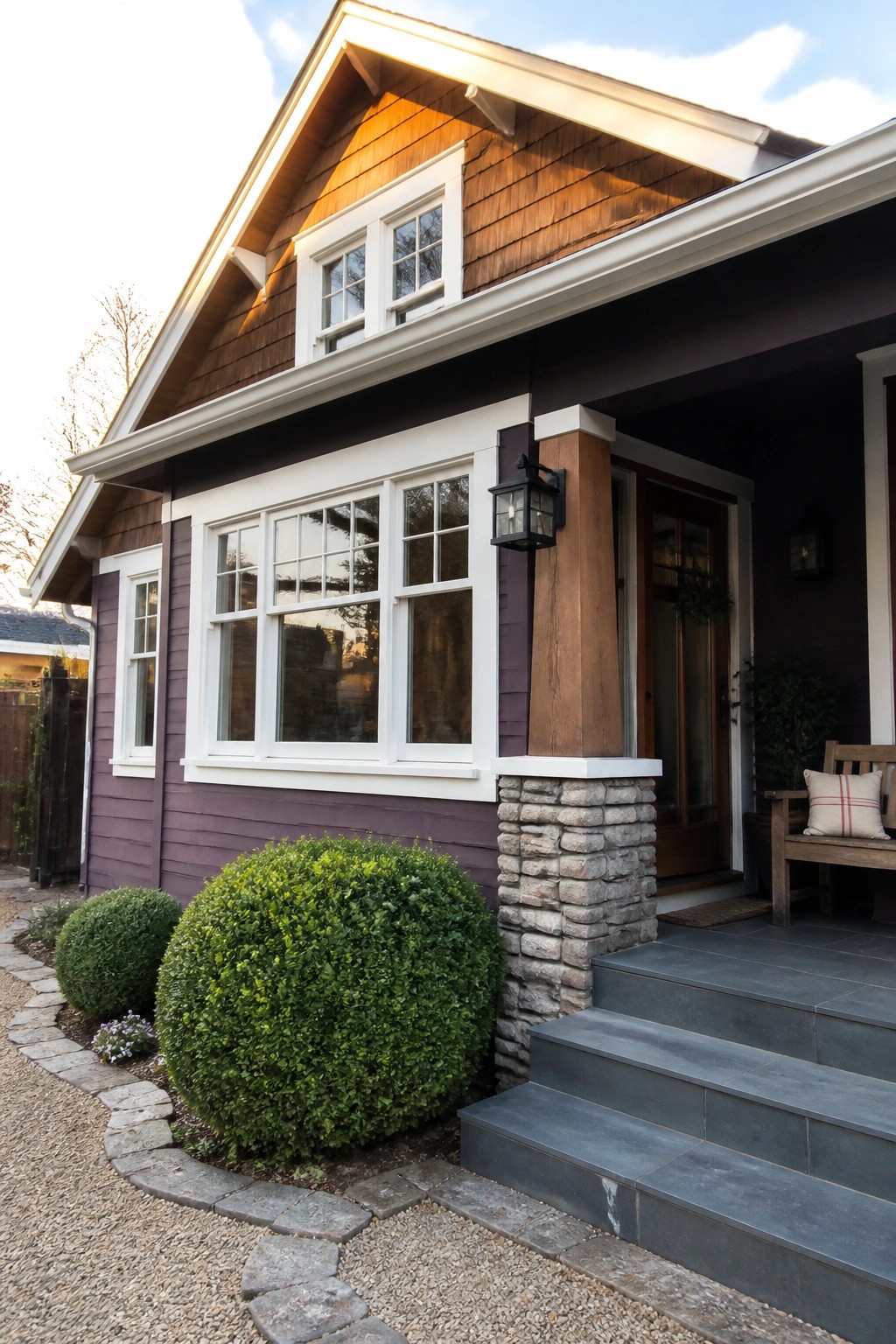 A house with purple siding, white window trim and eaves, a stone and wood porch column, and gray stone steps leading to the front door.