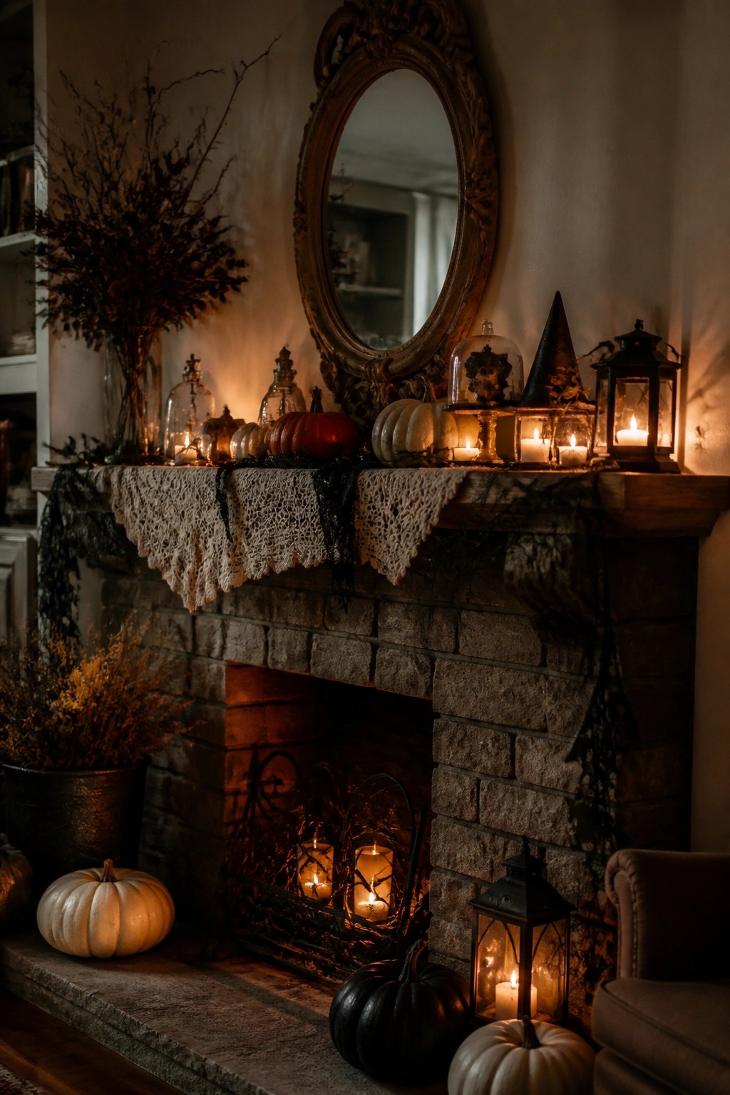 Stone fireplace mantel with pumpkins, candles, lanterns, lace runner, and ornate mirror.