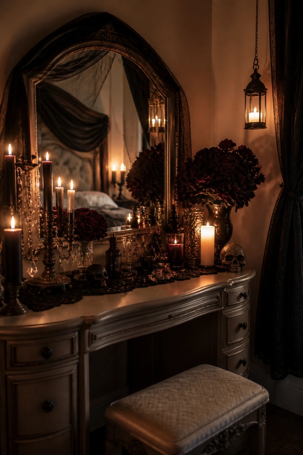 Gothic vanity with ornate mirror, lit candles, skulls, and dark red flowers