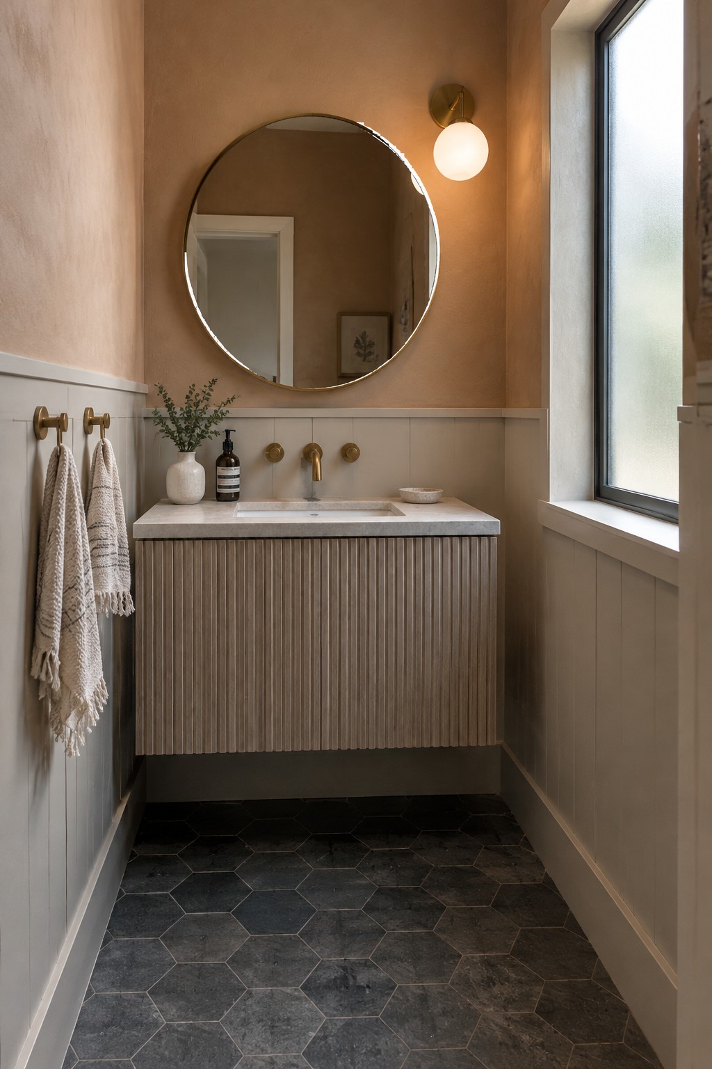 Warm greige bathroom walls above white tile and a wood vanity.