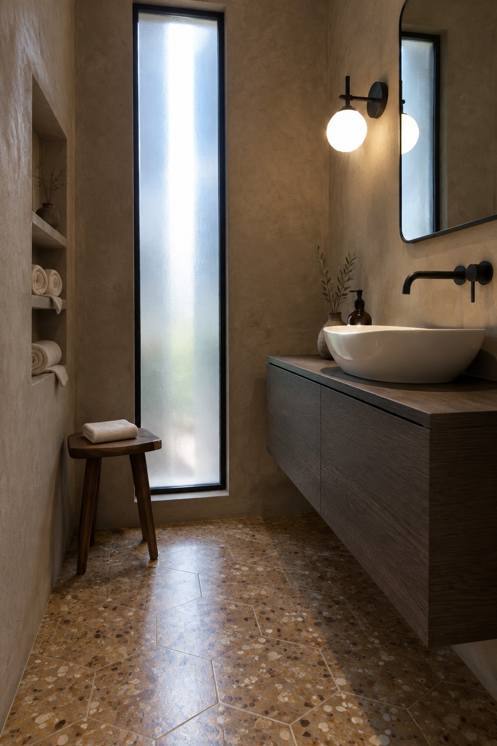 A narrow bathroom with a dark floating wood vanity, white vessel sink, frosted window, and patterned tile floor.