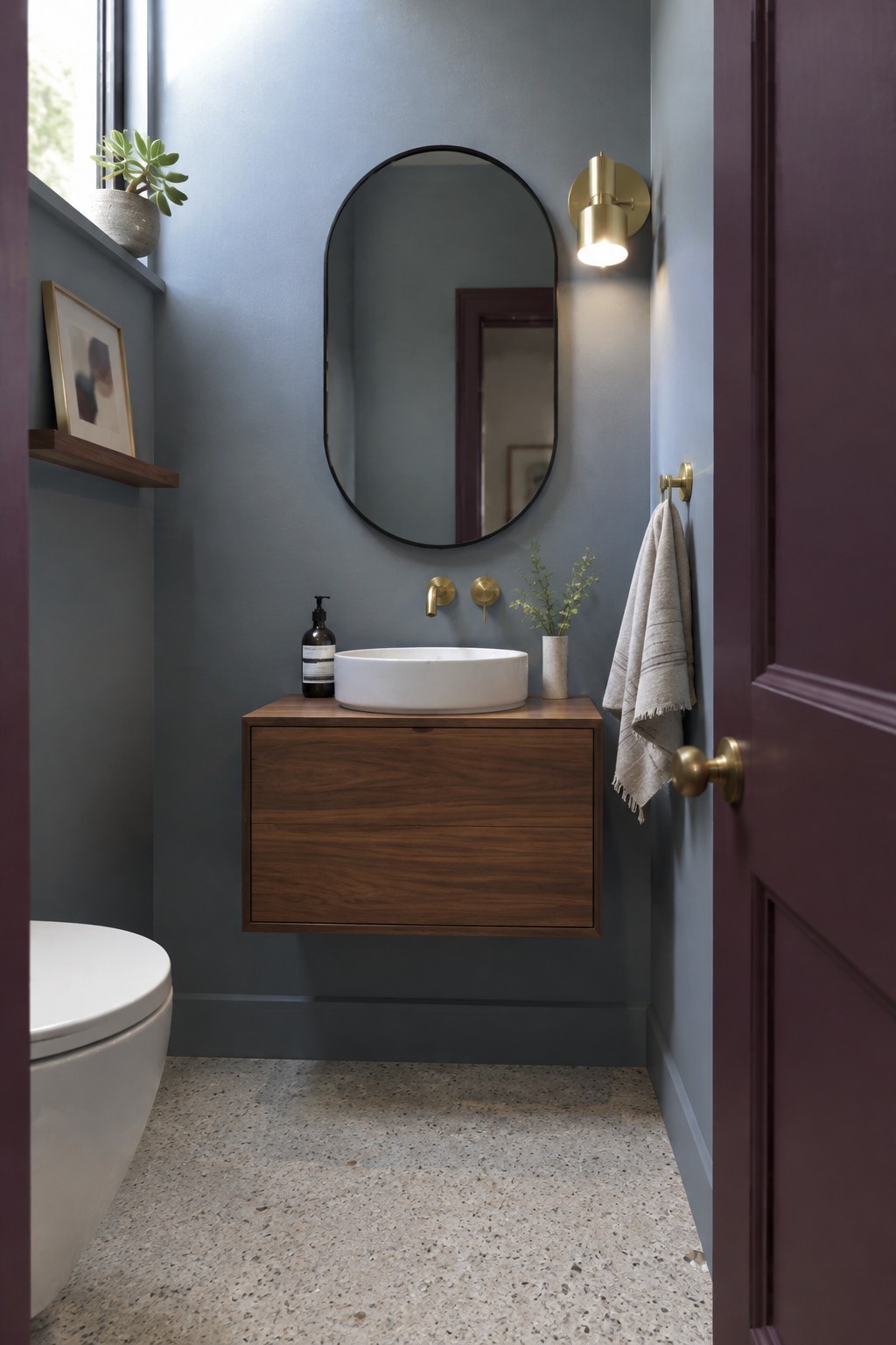 Muted blue-gray walls in a small bathroom with a walnut vanity.